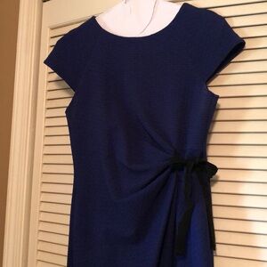 Flattering deep purple dress with black bow detail